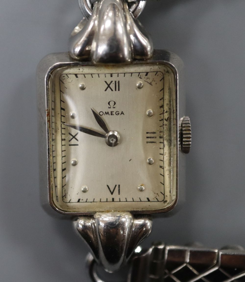 A ladys stainless steel Omega manual wind wrist watch, on associated bracelet.